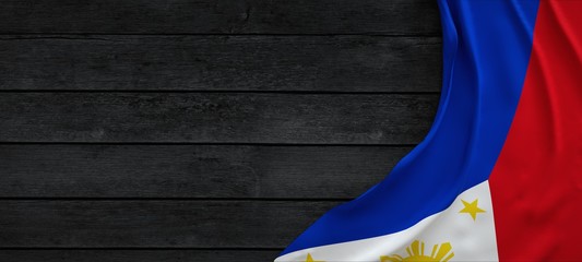 Flag of the Philippines, fabric on dark wood.