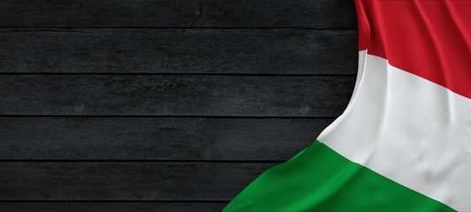 Flag of Italy, fabric on dark wood.