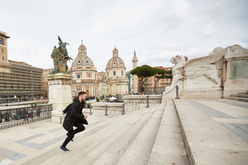 Obraz premium The guy quickly runs up the stairs in the Italian city of Rome