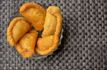 Top view of Gujia, a popular sweet dish prepared during the festival of Holi is very popular in North India served in a glass bowl on the occasion of Holi 