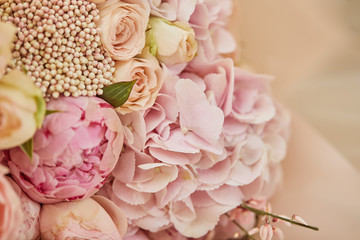 bouquet of roses and pink peonies on table