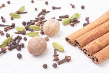 Different kind of spices on wooden background.