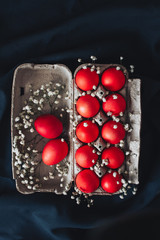 bright easter eggs in a stand with white flowers