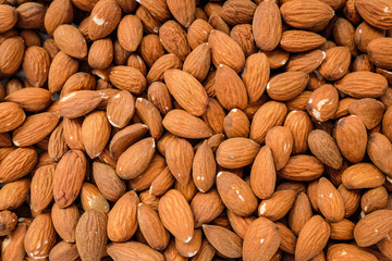 Raw peeled almonds background