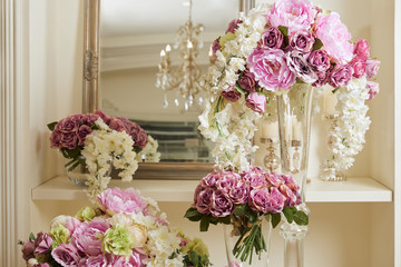 mirror, white and purple flowers in glass vases