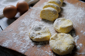 Dough for cheesecakes on the kitchen table