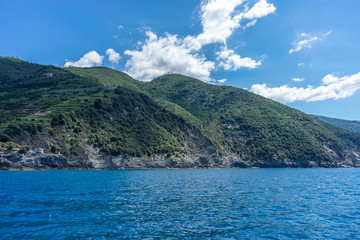 Italy, Cinque Terre, Monterosso, a large body of water with a mountain in the background