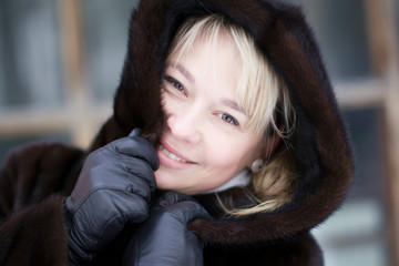 Portrait of a beautiful woman in a fur hood