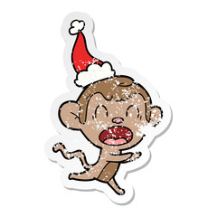 shouting distressed sticker cartoon of a monkey wearing santa hat