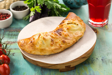 Cheese pie on a plate on blue wooden table