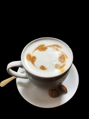 Top view of Cappuccino hot coffee with milk isolated on black background. 