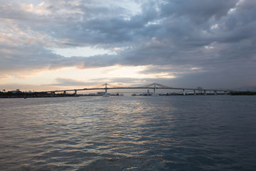 Fototapeta na wymiar two mactaqn bridges viewpoint from open sea site in dusk sunset with cloudy sky