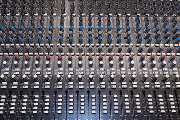 Abstract view of Professional audio mixing console with faders and adjusting knobs -Music / radio /...