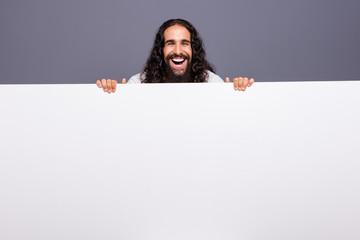 Portrait of his he nice handsome attractive cheerful cheery glad wavy-haired guy holding in hands large copy space novelty solution ad advert isolated over gray violet purple pastel background