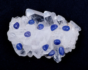 Soft blue violet TANZANITE extra quality beads from Tanzania on FADEN QUARTZ CLUSTER. Isolated on...