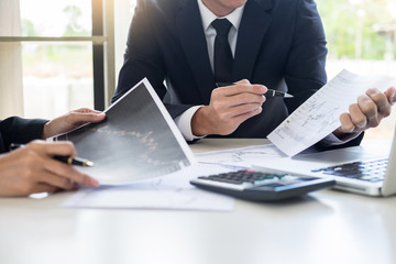 Business Team trader or broker Investment Entrepreneur colleagues working discussing and analysis graph stock market trading with forex chart data, financial, selling and buying concept