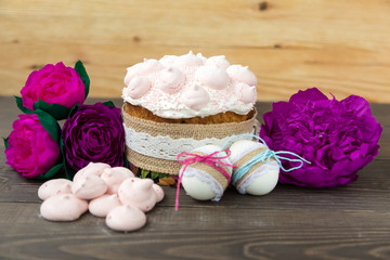 Obraz na płótnie Canvas Easter, holiday cake, sweets, meringues, flowers natural background, eggs, on a wooden table.