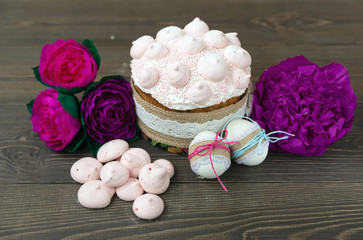 Obraz na płótnie Canvas Easter, holiday cake, sweets, meringues, flowers natural background, eggs, on a dark wooden table.