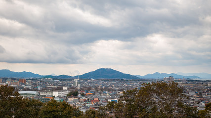 Panoramic, scenic landscape view with beautifully textured clouds that can be seen from Hikone Castle, located in the city of Hikone in Shiga Prefecture, Japan.