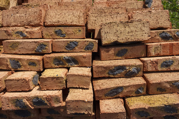 Red brick on the pallet. Texture. Close up