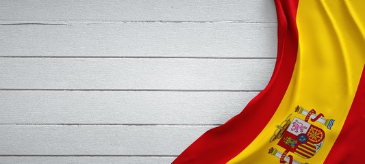 Flag of Spain, on top of white wood. Wrinkled fabric. - obrazy, fototapety, plakaty