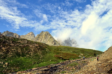 Fototapeta na wymiar Beautiful mountains and clouds landscape in the Kashmir Great Lakes trek which starts from Sonamarg to Naranag Village in Jammu & Kashmir, India. 