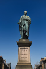 Fototapeta na wymiar Bronze sculpture of William Pitt the Younger a British Prime Minister on George Street Edinburgh Scotland with blue sky