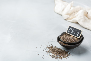 Obraz na płótnie Canvas Organic healthy chia seeds in a bowl, vegan superfood concept
