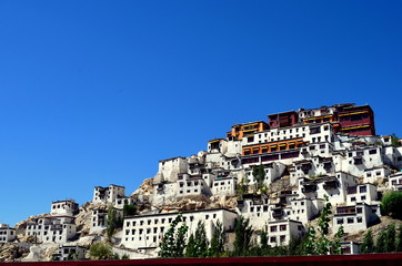 Full view of Thiksay Gompa / Monastery which is a gompa affiliated with the Gelug sect of Tibetan Buddhism. It's located on top of a hill in Thiksey, 19 kilometres east of Leh, in Ladakh, India.