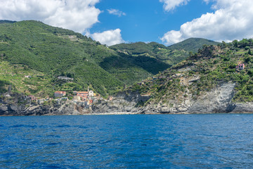 Fototapeta premium Italy, Cinque Terre, Monterosso, a large body of water with a mountain in the background