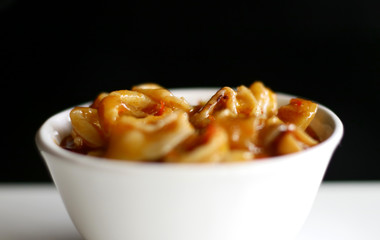 Cumi Saus Padang or Squid in Padang Sauce on black background. Spicy food from Padang, West Sumatra, Indonesia. 