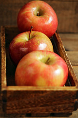 Fresh red apples on wood