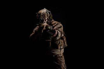 Special forces United States soldier or private military contractor holding rifle. Image on a black background. war, army and people concept