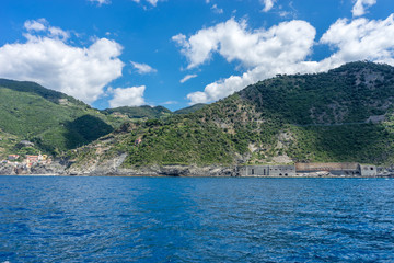 Italy, Cinque Terre, Monterosso, a large body of water with a mountain in the background