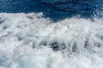Italy, Cinque Terre, Monterosso, a person riding a wave on a surfboard in the ocean