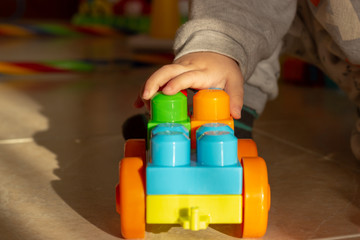 Naklejka premium child playing with plastic blocks