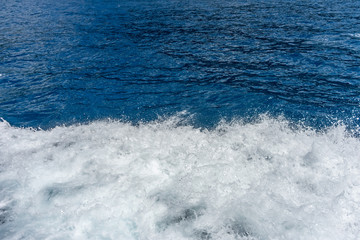 Italy, Cinque Terre, Monterosso, a man riding a wave on top of a body of water