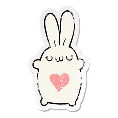distressed sticker of a cute cartoon rabbit with love heart