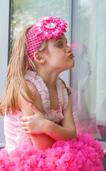 Portrait of  Angry Little Girl who Squints Funny Grimaces