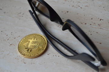 Cryptocurrency coin on sunglasses background