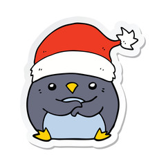 sticker of a cute cartoon penguin wearing christmas hat