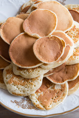 Small pancakes on a plate.