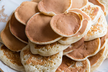 Small pancakes on a plate.
