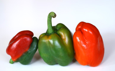 Red and green paprika on white background.