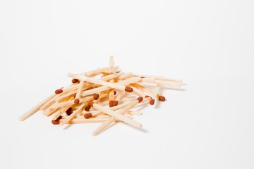 A pile of scattered wooden matches.