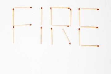 Inscription FIRE written with wooden matches - keep out of reach of children.