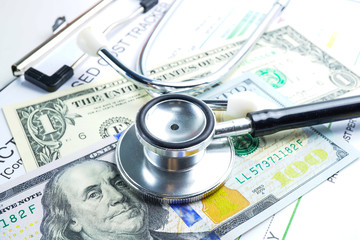 Stethoscope on US dollar banknotes, Finance, Account, Statistics, Analytic research data and Business company meeting concept