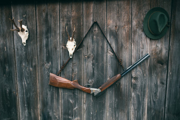 Professional hunters equipment for hunting. Rifle, Deer, Roe deer trophy sculs and others on a...
