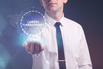 The concept of business, technology, the Internet and the network. A young entrepreneur working on a virtual screen of the future and sees the inscription: Change management