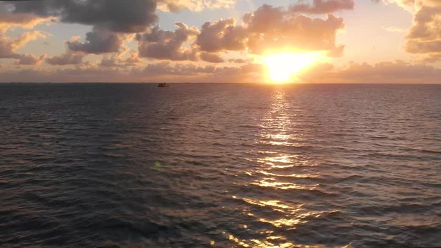 Aerial footage of a passenger and car ferry that goes between Isla Mujeres and Cancun in Mexico at sunrise.